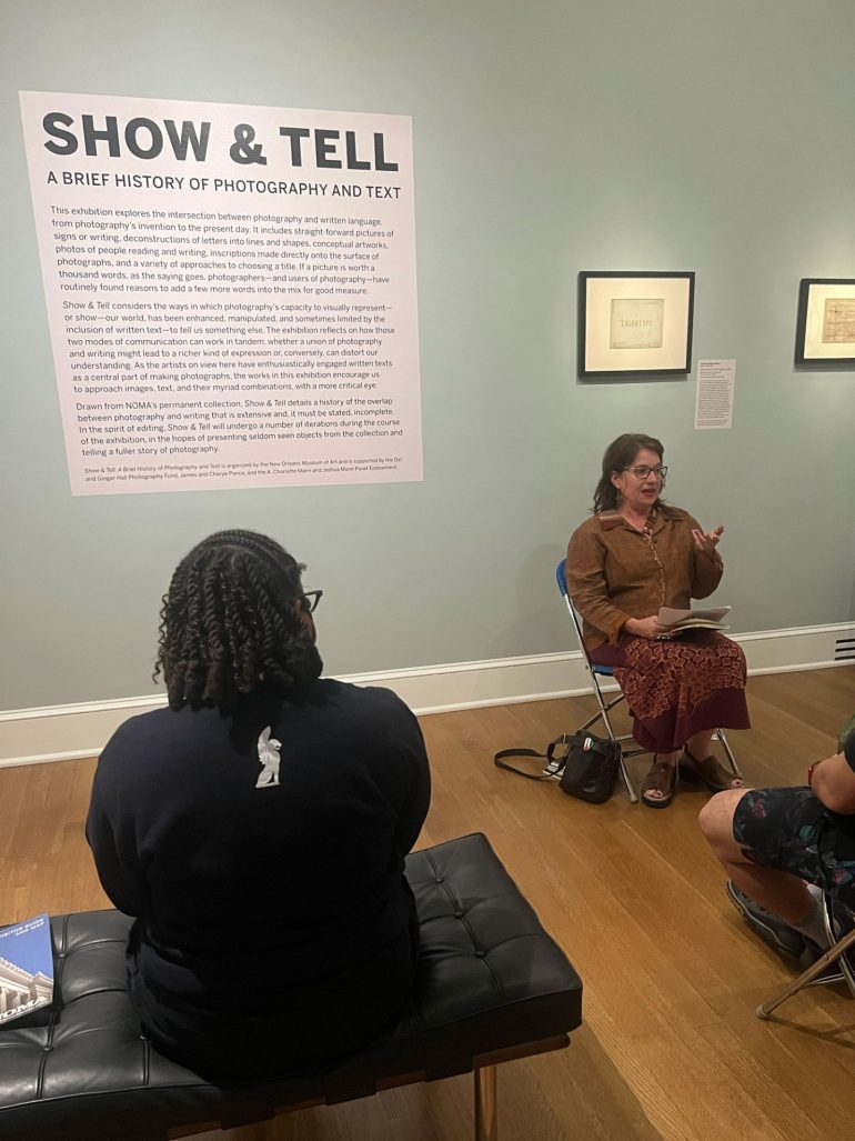 Poet Andy Young addresses a crowd at the closing of the exhibit "Show and Tell: A Brief History of Photography and Text"